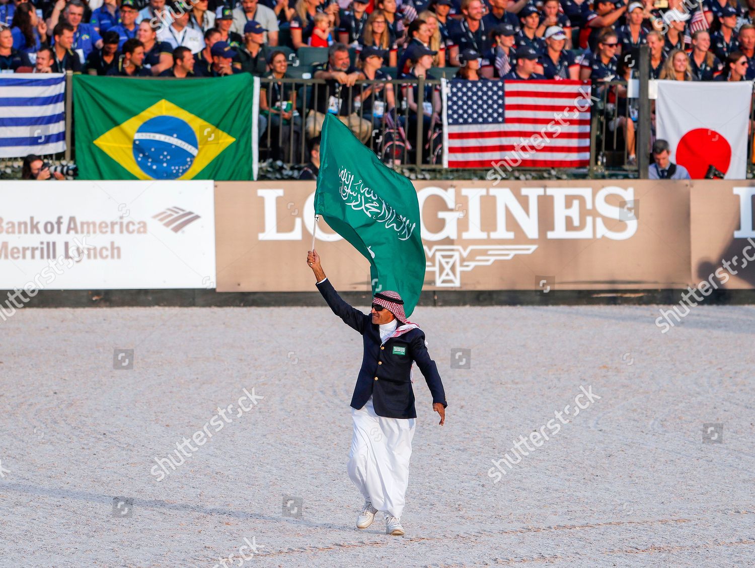 Tarek Taher raising the Saudi flag